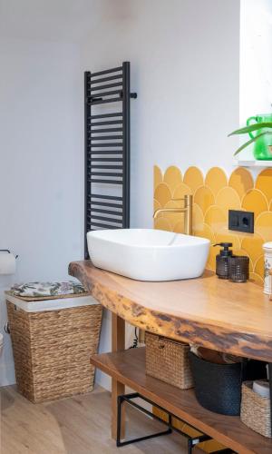 a bathroom with a sink on a wooden table at El Sueño, La Perla in Barres