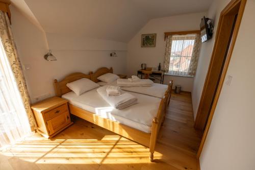 a bedroom with a bed with white sheets at Anivina - B&B in Ivanjkovci
