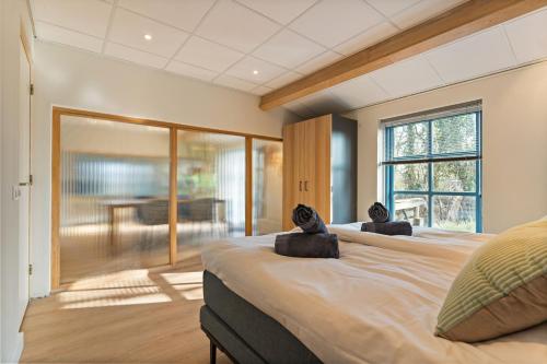 a bedroom with a large bed with two animal pillows on it at Boerderij appartement 't Vogelnest in Heiloo