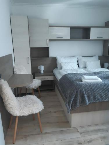 a bedroom with a bed and a table and chairs at HunGasthaus 08 in Mariazell