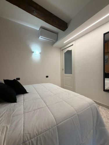 a bedroom with a white bed and a window at Suite romantica a Como Centro in Como