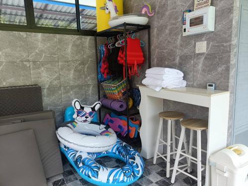a room with a toilet and a table and stool at Than Khao Nature Resort and Homestay - Krabi Noi in Krabi
