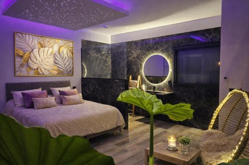 a bedroom with a bed and a table and a mirror at Suite neuve piscine privée Les Charmettes in La Ciotat