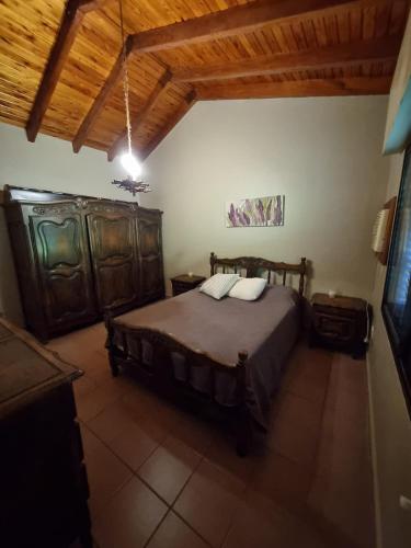 a bedroom with a large bed and wooden furniture at Casa a metros de todo in Federación