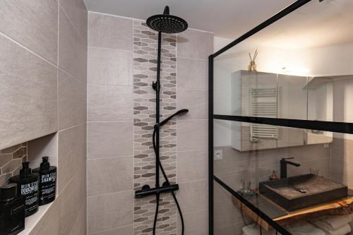 a bathroom with a shower with a sink and a shower at Résidence Espéraza ADULTS ONLY in Espéraza