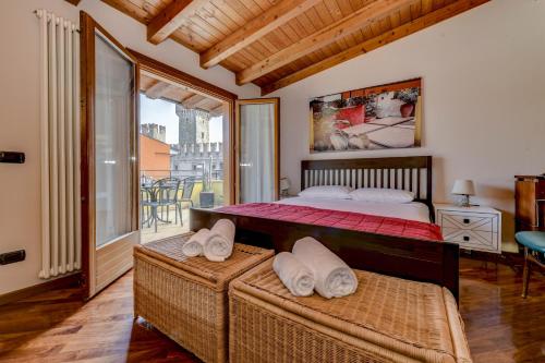 a bedroom with a bed and a balcony at Luxury Castle View in Sirmione