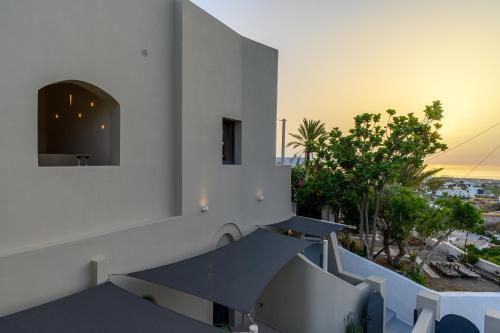 a view from the balcony of a house at Hotiday Santorini Mesaria in Fira