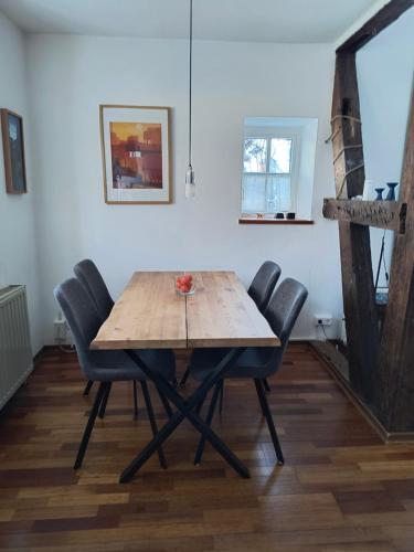 a dining room with a wooden table and chairs at Fewo Haus Patze in Betzendorf