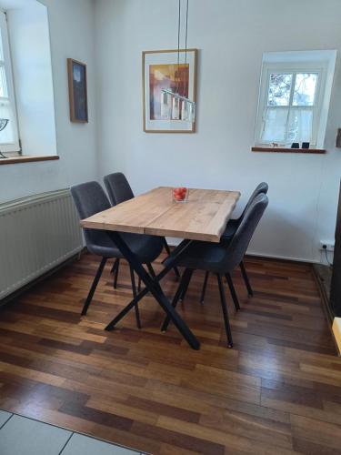 a wooden table and chairs in a room at Fewo Haus Patze in Betzendorf
