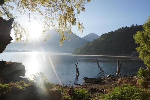 a view of a lake with a boat in the water at Patziapa in Santiago Atitlán