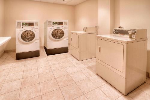 a laundry room with three washing machines and a washer and dryer at Fairfield Inn & Suites by Marriott Destin in Destin