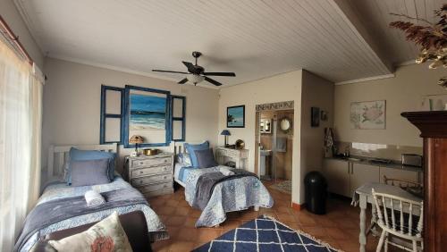 a bedroom with two beds and a ceiling fan at AtHome Apartments in Mokopane