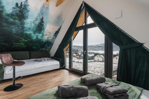 a bedroom with a bed and a large window at LakeHome&Spa nad Jeziorem Czorsztyńskim in Kluszkowce