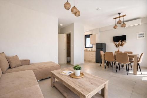 a living room with a couch and a table at Ariadne Stay Complex by Horizon Homes in Ofrínion