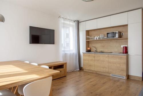 a kitchen with a table and a sink and a counter at Apartmány Pec pod Sněžkou in Pec pod Sněžkou