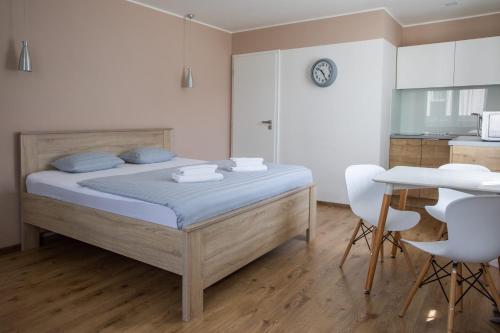 a bedroom with a bed and a table and chairs at Apartmány Pec pod Sněžkou in Pec pod Sněžkou