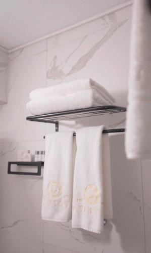 a towel rack with towels on it in a bathroom at La Vista in Gaziemir