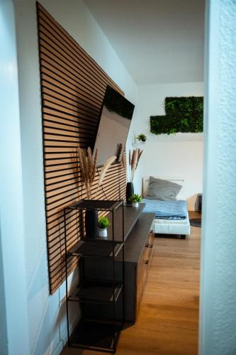 a living room with a counter and a bed at Wohnung am See in Wetter