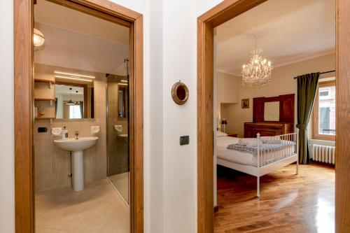 a bathroom with a sink and a bedroom with a bed at Central Square in Sirmione
