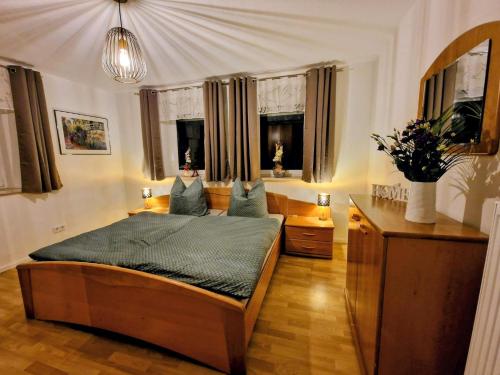 a bedroom with a bed in a room with windows at Haus am Thiesenring in Bad Berneck im Fichtelgebirge