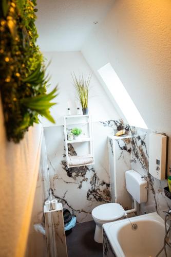 a bathroom with a toilet and a sink at Wohnung am See in Wetter