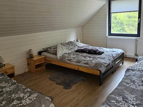 a bedroom with two beds in a room at Lakeforest Dedinky Wellness Chata privát jacuzzi aj sauna, výhľad na jazero in Dedinky