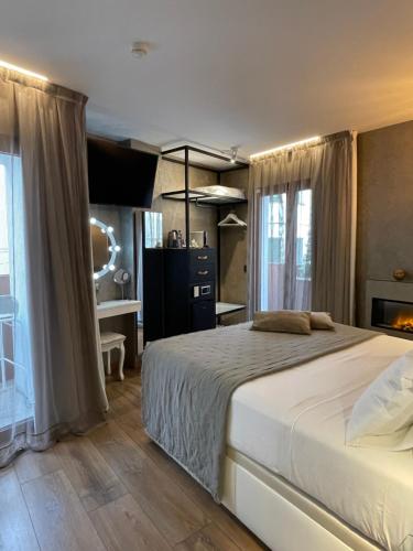 a bedroom with a large bed and a bathroom at Mamma Mia Hotel Boutique - Only Adults in Tossa de Mar