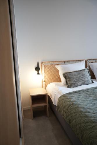 a bedroom with a bed and a night stand with a lamp at Rezidence Jakubská in Brno