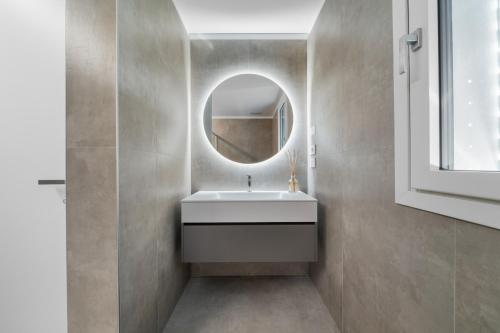a bathroom with a white sink and a mirror at NNV Pool Villa Lazise in Lazise