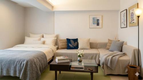 a living room with two beds and a couch at Newly Renovated 2025 秋リフォーム済 RC205 in Tokyo