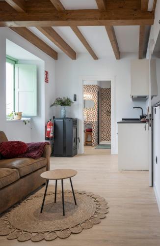 a living room with a couch and a table at El Sueño, Paca in Barres