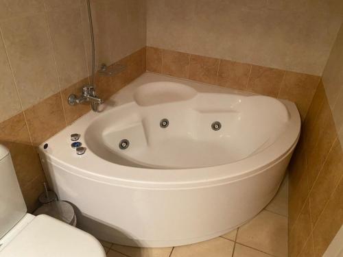 a white bath tub in a bathroom next to a toilet at Villa Effie in Aspro Chorio Paros