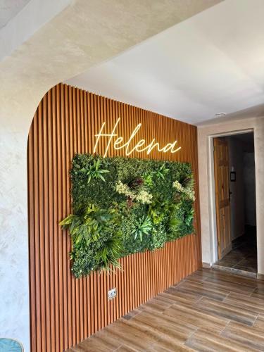 a wall with a sign that says heal at Helena Guest House - Pool & Sea View in Balchik