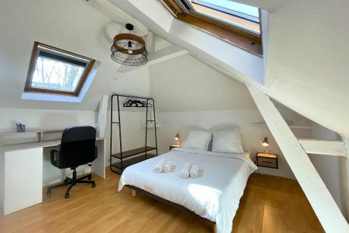 a bedroom with a bed and a desk and a window at L'Éclipse - Gare de Melun in Melun