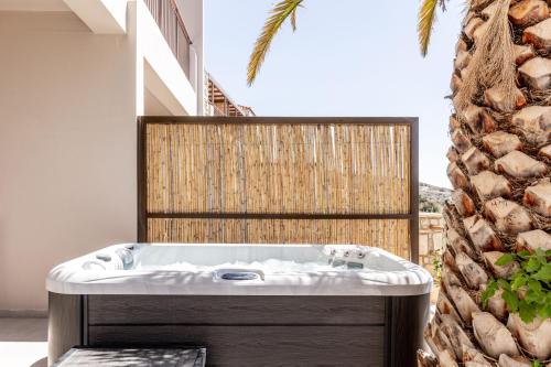 a bath tub sitting in the middle of a room at Casa Elounda - Adults only Hotel "by Checkin" in Agios Nikolaos