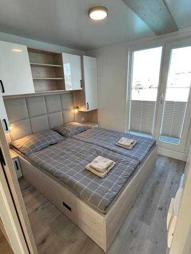 a bedroom with a bed with two towels on it at Hausboot Santa Lucia Novigrad - Floating Sea House in Novigrad Istria