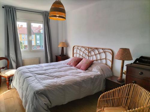 a bedroom with a bed and a chair and a window at Salinas en el horizonte in Salinas