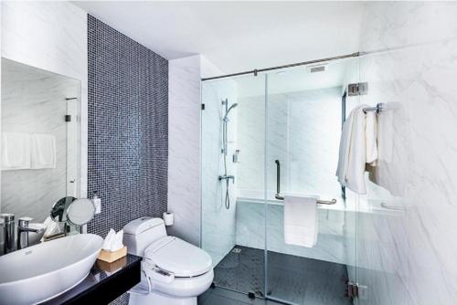 a bathroom with a toilet and a sink and a shower at Therizinpattaya in Pattaya South