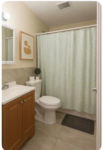 a bathroom with a toilet and a shower curtain at Omaha Wynwood in Miami