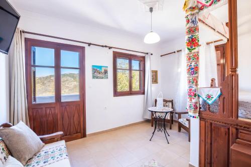 a living room with a door and a table at Sofia Mike Houses in Olympos