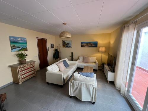 a living room with a couch and a table at Close to the beach duplex in Tossa de Mar