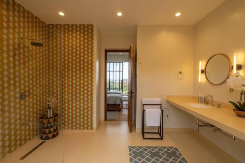 a bathroom with a sink and a mirror at Rubi Ranch Lakehouses in Naivasha