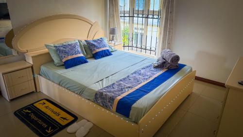 a bedroom with a bed with a large window at The Aviators Villa in Flic-en-Flac