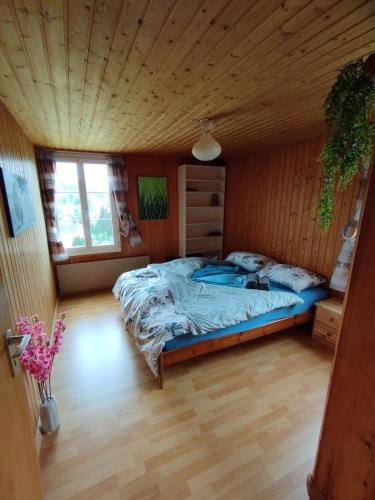 a bedroom with a bed and a wooden ceiling at Gemütliche Wohnung im Grünen in Herisau