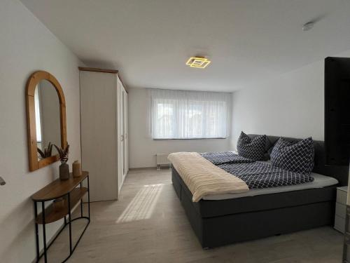 a bedroom with a bed and a mirror in it at Schwarzwald Loft in Villingen-Schwenningen