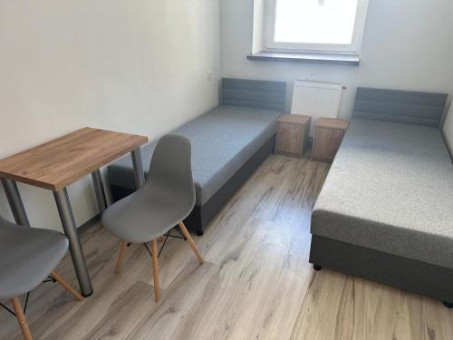 a room with a bed and a table and chairs at Mieszkateria in Piotrków Trybunalski