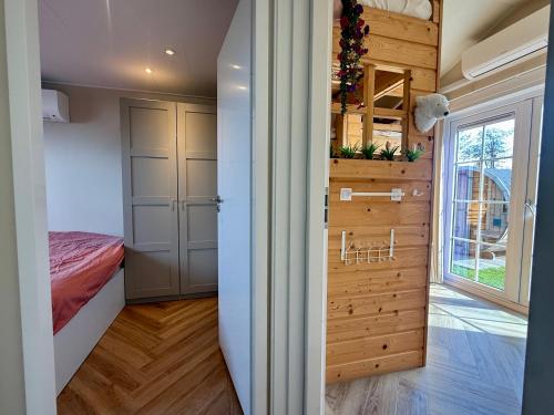 a small bedroom with a bed and a window at NEW - Private Residence with Sauna - on a lake near Amsterdam in Vinkeveen