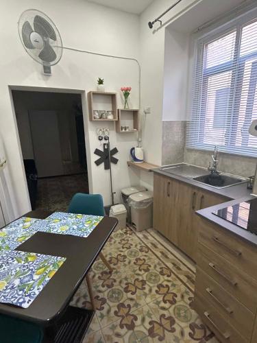 a kitchen with a table and a sink and a counter at Coral Reef Charming studio by the three old cities in Cospicua