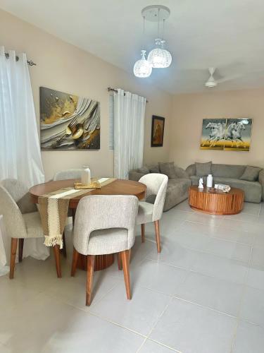 a living room with a table and a couch at Casa Mar y Campo in San Felipe de Puerto Plata