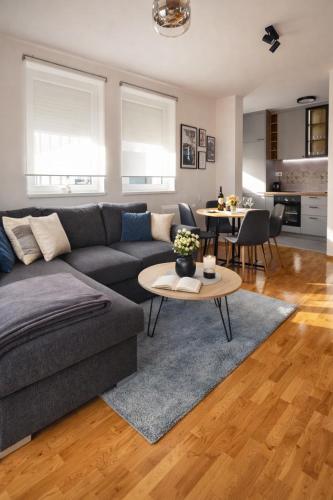 a living room with a couch and a table at Apartman River in Bijeljina